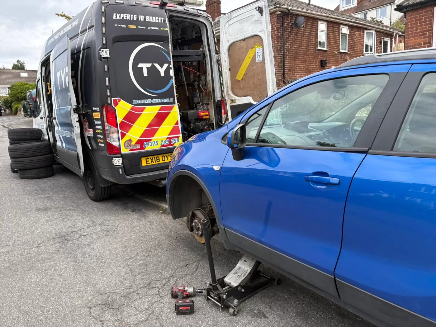 Tyres On The Go van beside a blue car during a mobile tyre call-out
